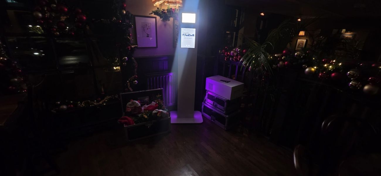 Christmas party guests using a Surrey FaceBooth photo booth at The Drummond